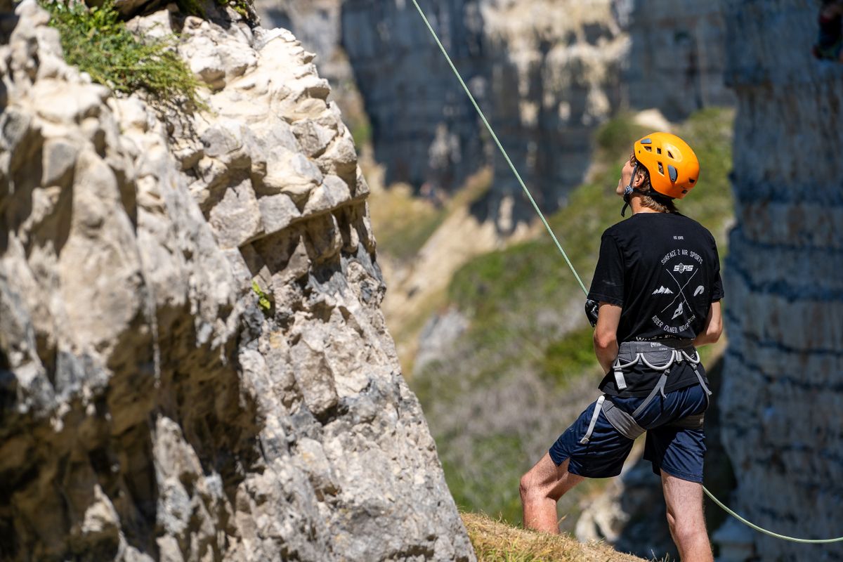 A man belaying next to a block towards its' side